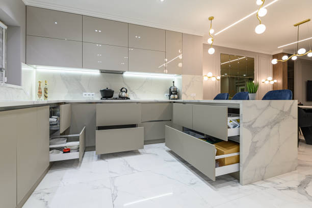 Open drawers at modern white kitchen furniture