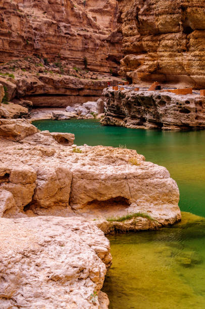 istock Hiking along Wadi Ash Shab in Oman 1297586634