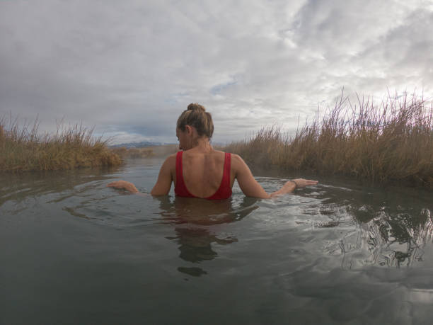 istock Young woman bathing in natural springs water 1297587603