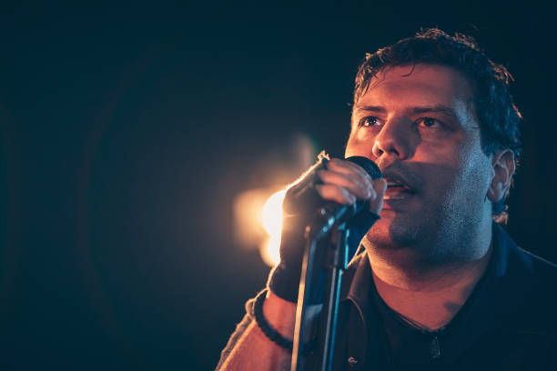 istock Male singer with microphone 1297587740