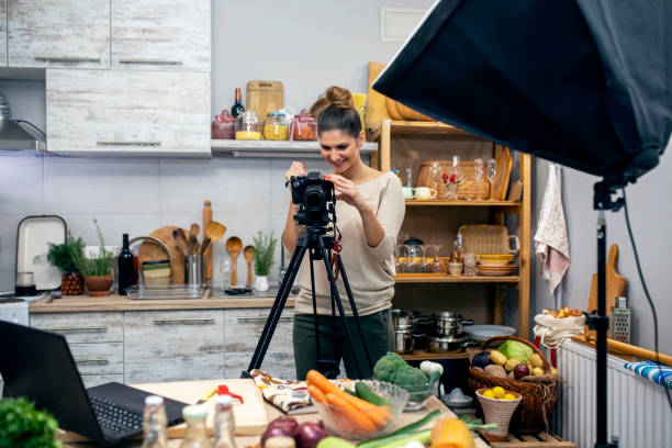 istock Young woman in her kitchen creating a cooking vlog 1297589300