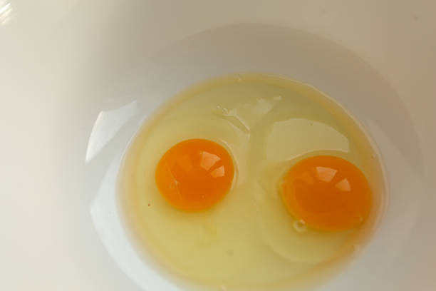 istock Raw eggs in a bowl for making an omelet or dough, top view 1297589984