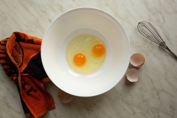 istock Raw eggs in a bowl for making an omelet or dough, top view 1297590581