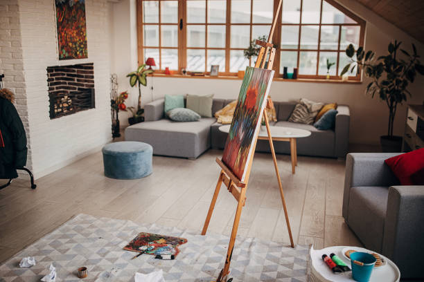 istock Modern painting on easel in empty apartment 1297590676