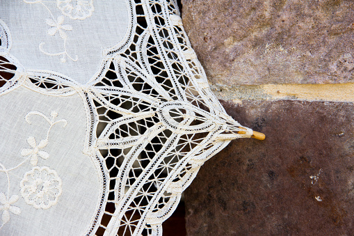 Embroidered fabric umbrella or parasol on the wall.