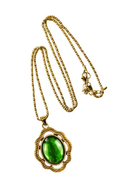 Vintage gold necklace with large emerald pendant isolated over white