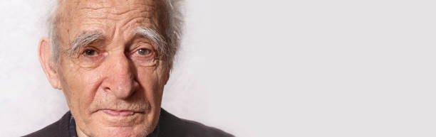Elderly man portrait. Close up. Glaucoma in left eye. Getting Old concept. Gray eyebrows and hair. Amazingly beautiful old man. Kindness in his eyes. Retired.