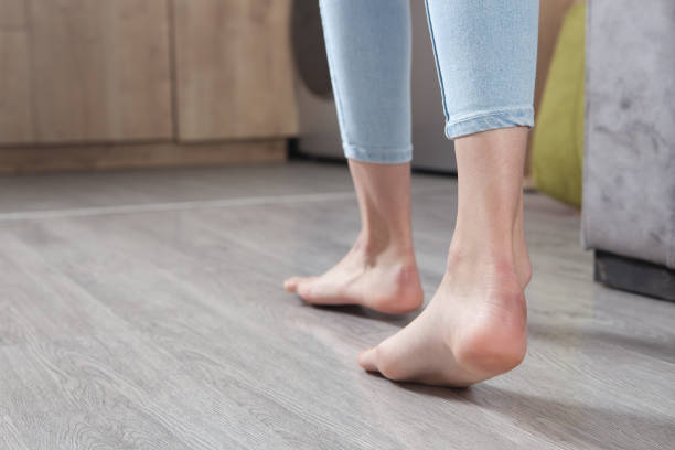 istock Female feet walking on floor at home. 1297592726