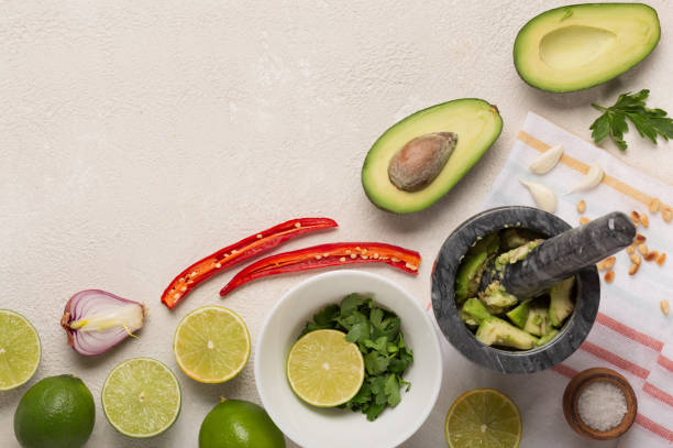 istock Ingredients for Mexican Sauce Guacamole cooking background. top view 1297593395