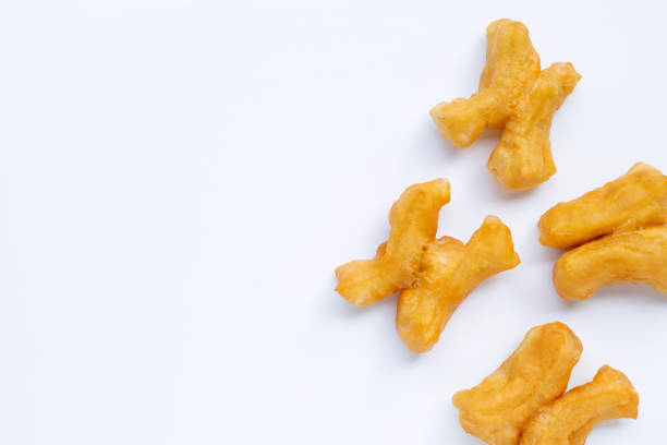 istock Deep-fried dough stick, chinese bread stick on white background with copy space 1297594219