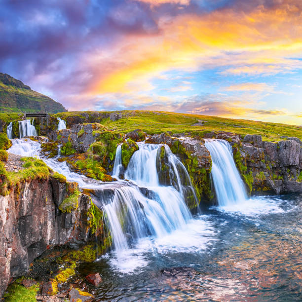 Fantastic view on Kirkjufellsfoss waterfall  near Kirkjufell mountain at sunset Fantastic view on Kirkjufellsfoss waterfall  near Kirkjufell mountain at sunset.  Location: Kirkjufellsfoss, Grundarfjordurn, Iceland, Europe kirkjufell stock pictures, royalty-free photos & images