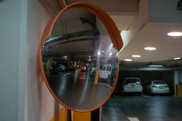 istock Curve mirror at a basement parking.Traffic mirror safety and security concept. Selective focus 1297595930