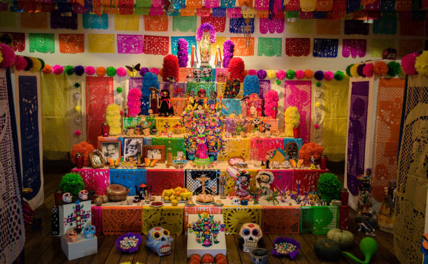 Halloween celebrations - Altar for day of the dead with candles, Mexican skulls, crosses and pumpkins stock photo