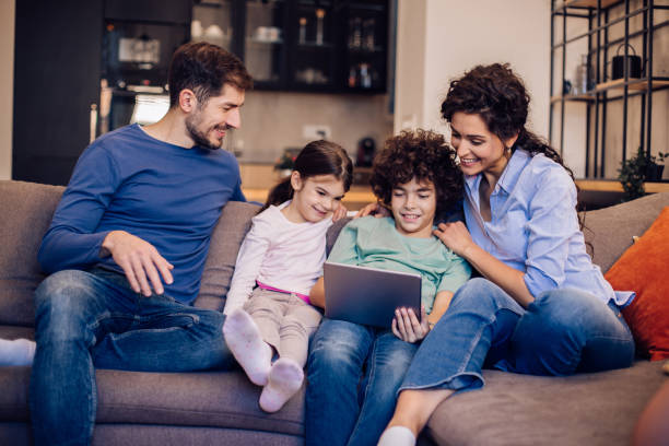 istock Happy family enjoying their weekend evening watching something online 1297597955