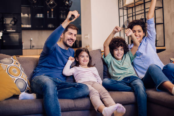 istock Family having fun watching TV for weekend 1297597960