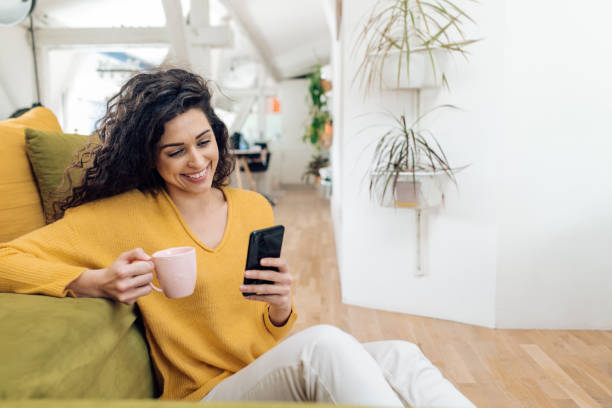 istock Beautiful woman having a coffee break while working from home 1297598305