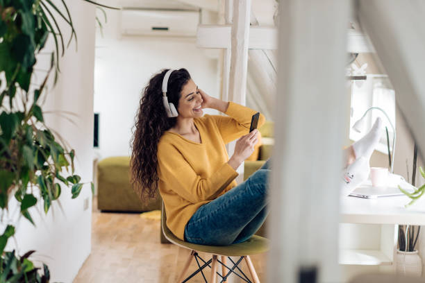 istock Beautiful young woman enjoying music after work 1297598309