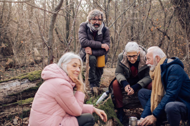 istock Group of seniors making coffee and taking a break during hiking 1297599083