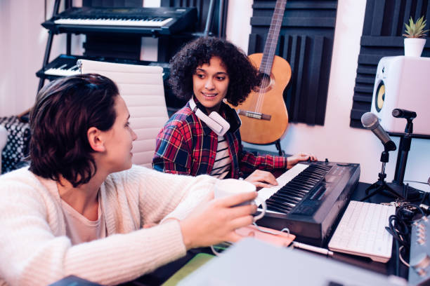 istock Two young musicians working in the music studio 1297599126