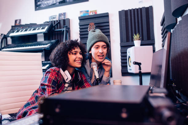 istock Two girls mixing music on the computer at the music studio 1297599132