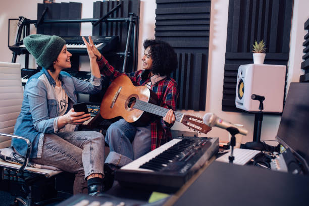 istock Two musicians celebrating success while recording a song 1297599154
