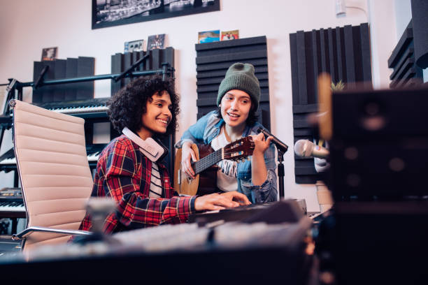 istock Two gifted musicians making modern music at the studio 1297599161