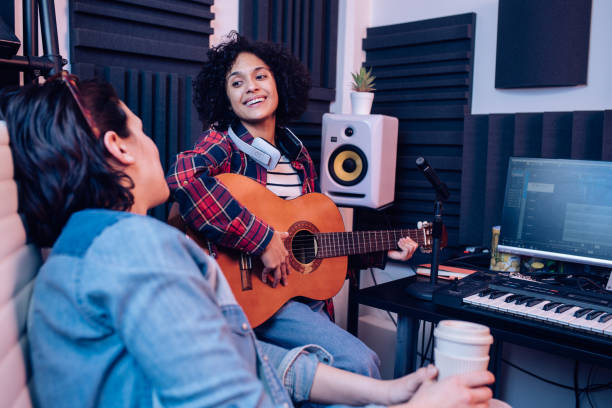 istock Two friends musicians working together at the music studio 1297599162