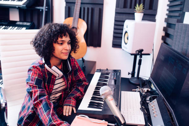 istock Girl creating music in the music studio 1297599176