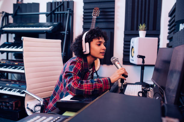 istock Young singer recording a song at the music studio 1297599179