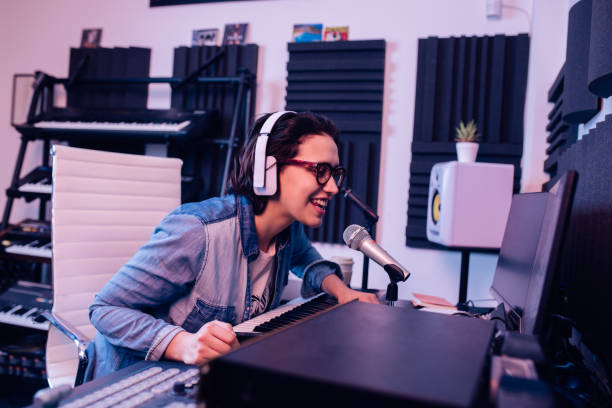 istock Happy musician creating a new song at the recording studio 1297599193