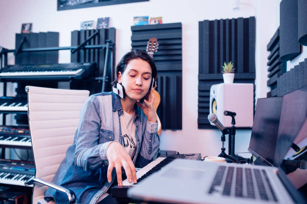 istock Young musician playing and composing music in the studio 1297599198