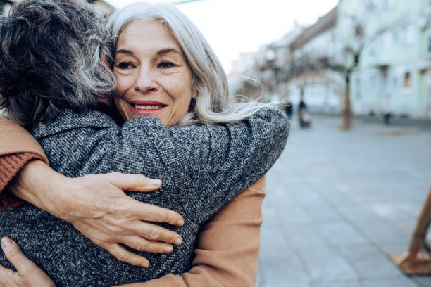 istock Happy senior woman embracing her husband 1297599280