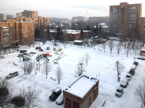 istock Top view from the window on snow-covered courtyard with playground on winter day 1297599300