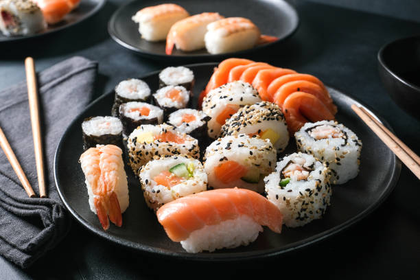 lunch at the sushi bar set of sushi and rolls - sushi sashimi nigiri salmon imagens e fotografias de stock
