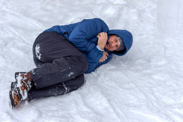 istock Man mountaineer lying ill with hypothermia on snow. 1297600590