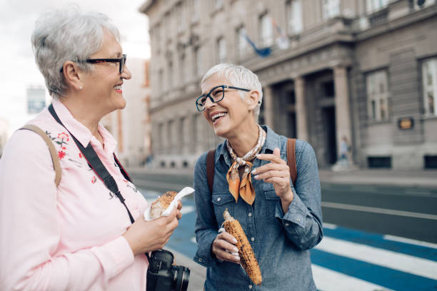 istock Two old friends snacking corn and enjoying their vacation 1297601104