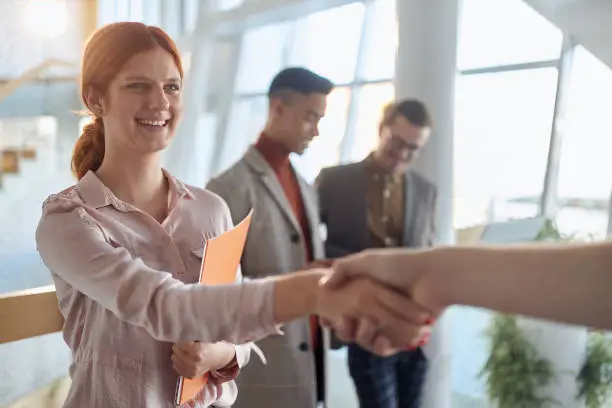 Photo of A young female employee has a business meeting at company. People, job, company, business concept.