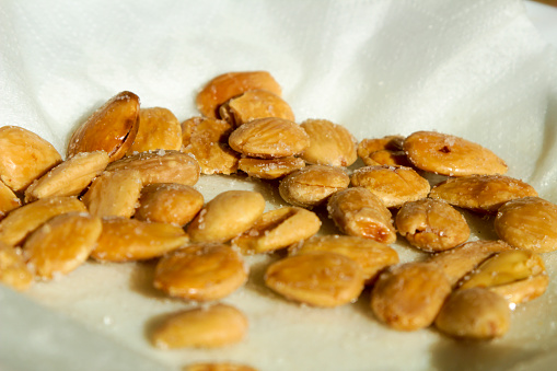 Typical Tasty Spanish Tapa of fried almonds with salt on dish