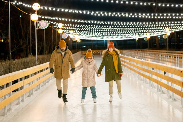 istock Family skating on rink 1297603930