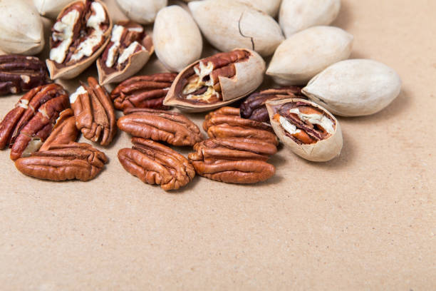 istock Carya illinoinensis nuts. Peeled and whole pecans close-up. 1297604251