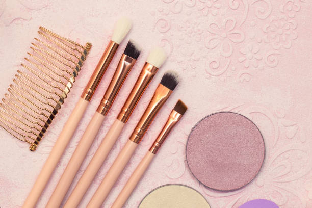 istock Makeup brushes, powder and other cosmetic items on a beige background 1297604528