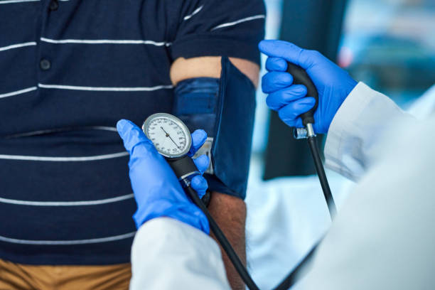 Taking accurate measurements to make a clear diagnosis Closeup shot of a doctor examining a patient with a blood pressure gauge artery photos stock pictures, royalty-free photos & images