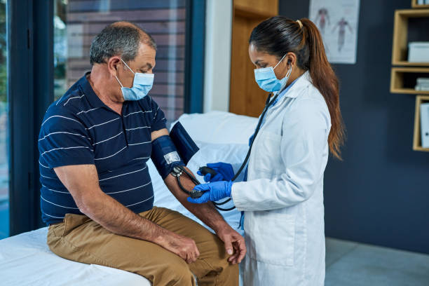 You may be at risk for heart disease and stroke Shot of a doctor examining a senior patient with a blood pressure gauge hypertensive photos stock pictures, royalty-free photos & images