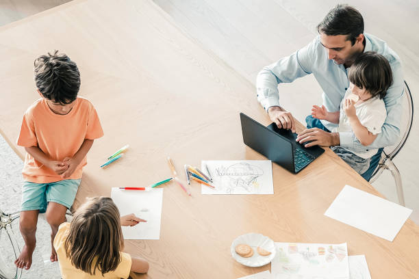 istock Top view of father with kids sitting at table 1297604674