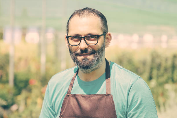 istock Happy male gardener standing and posing 1297606328