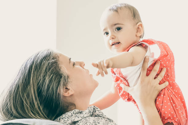 istock Mom holding baby in arms 1297608374