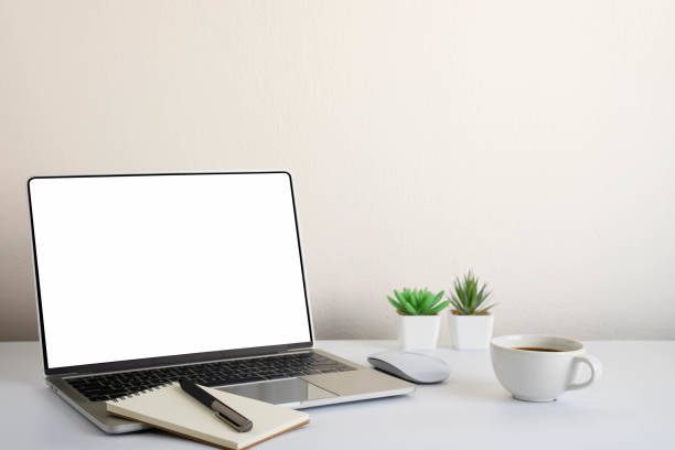 istock White office desk table with keyboard of laptop, coffee cup and notebook, mouse computer with equipment office supplies. Business and finance concept. Workplace, Flat lay with blank copy space. 1297608388