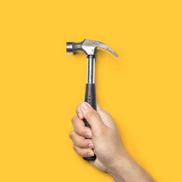 istock Person holding a small hammer with a black handle. 1297610062