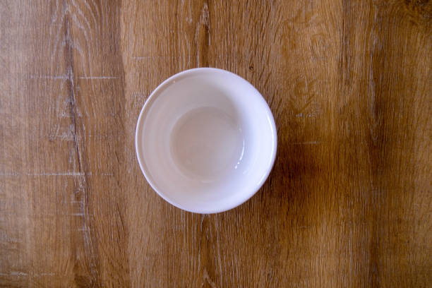 istock Top view of empty bowl on wooden background with copy space 1297611557