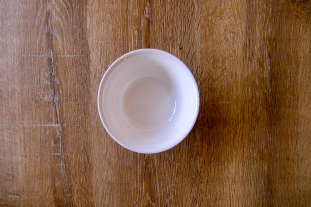 istock Top view of empty bowl on wooden background with copy space 1297611567